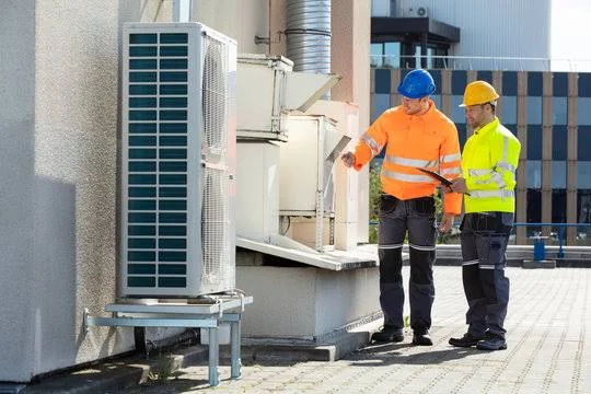 Illustrative commercial HVAC equipment inspection beside an outdoor unit